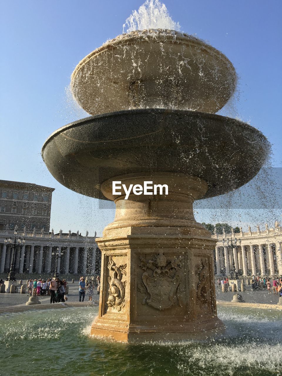 FOUNTAIN WITH BUILDINGS IN BACKGROUND