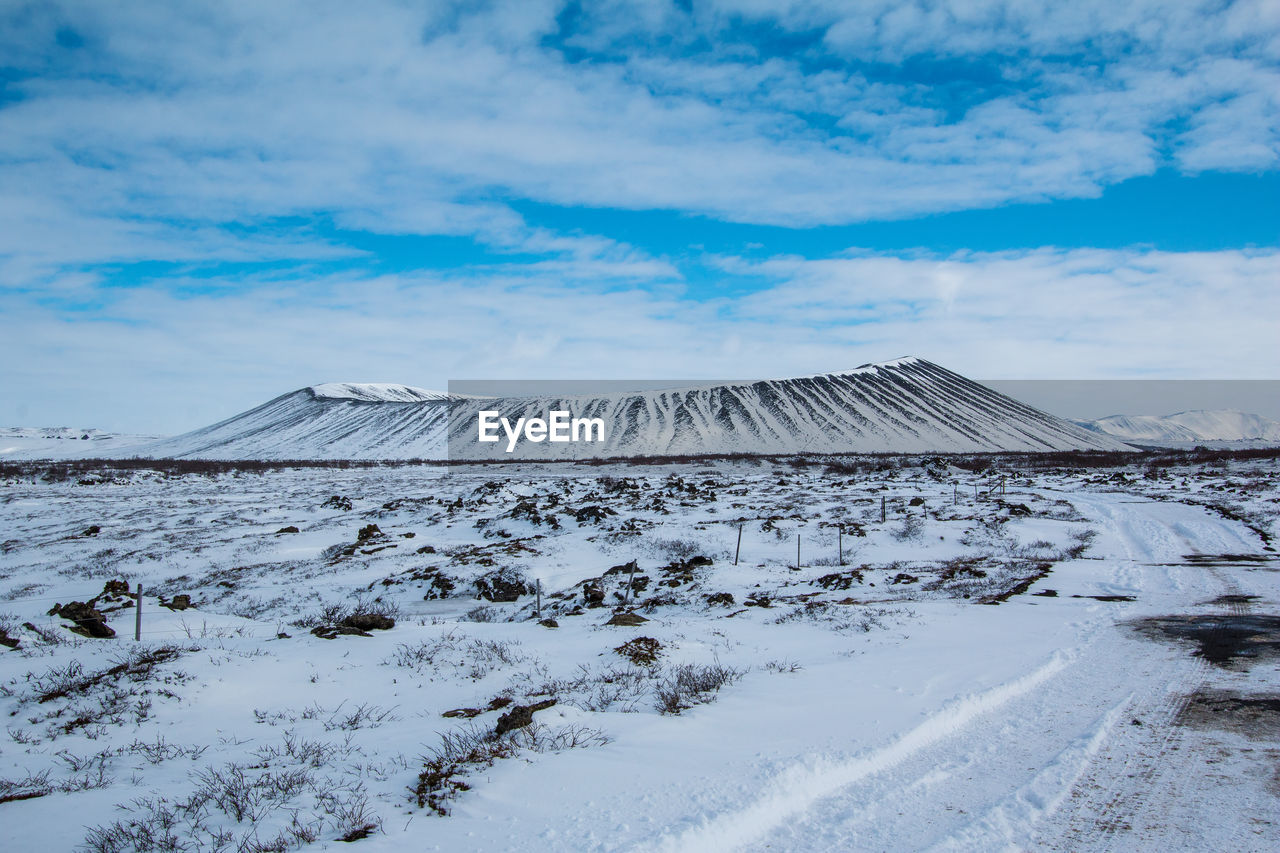 Scenic view of snow covered landscape against sky