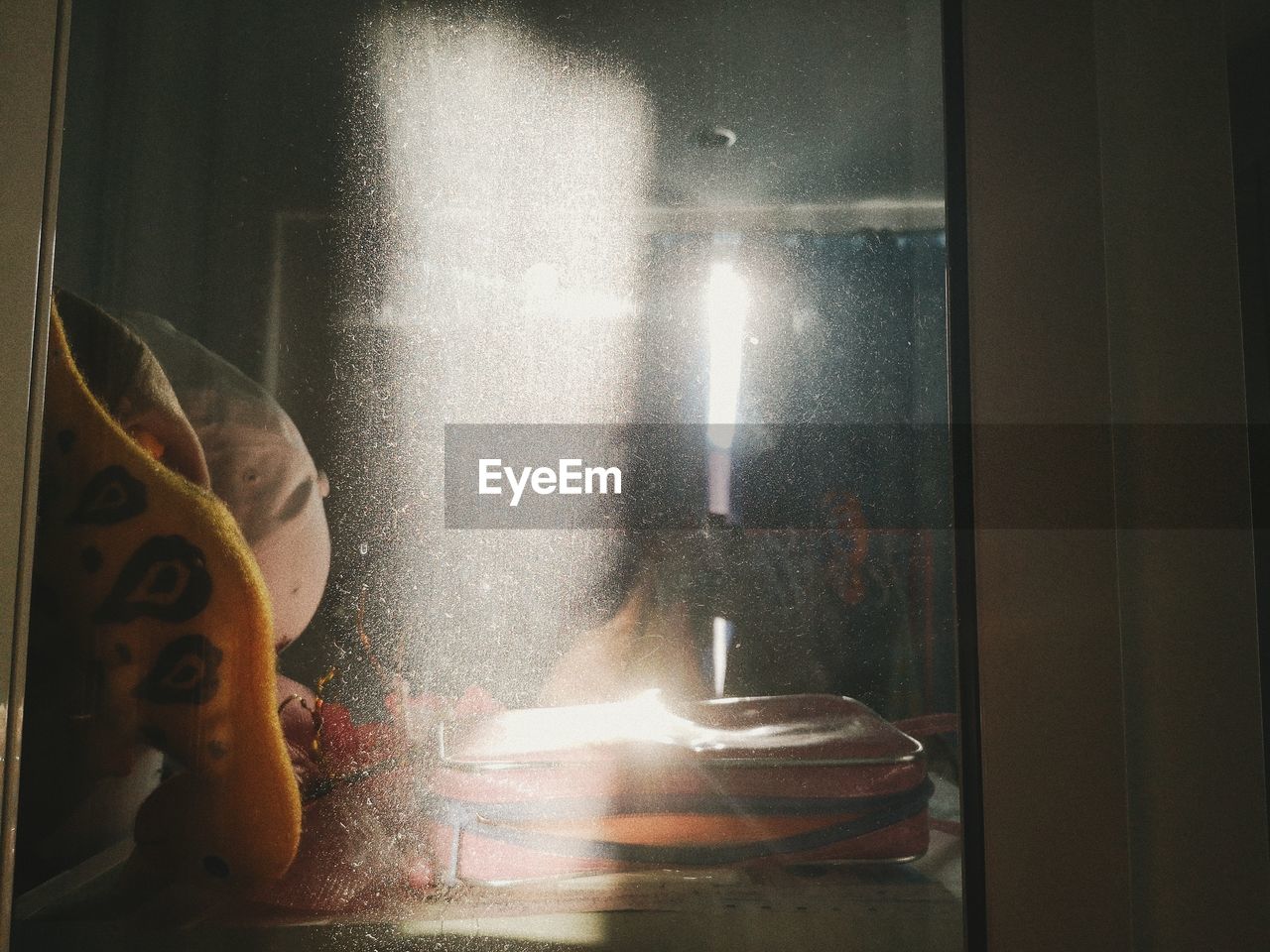 DIGITAL COMPOSITE IMAGE OF TOY SEEN THROUGH WINDOW