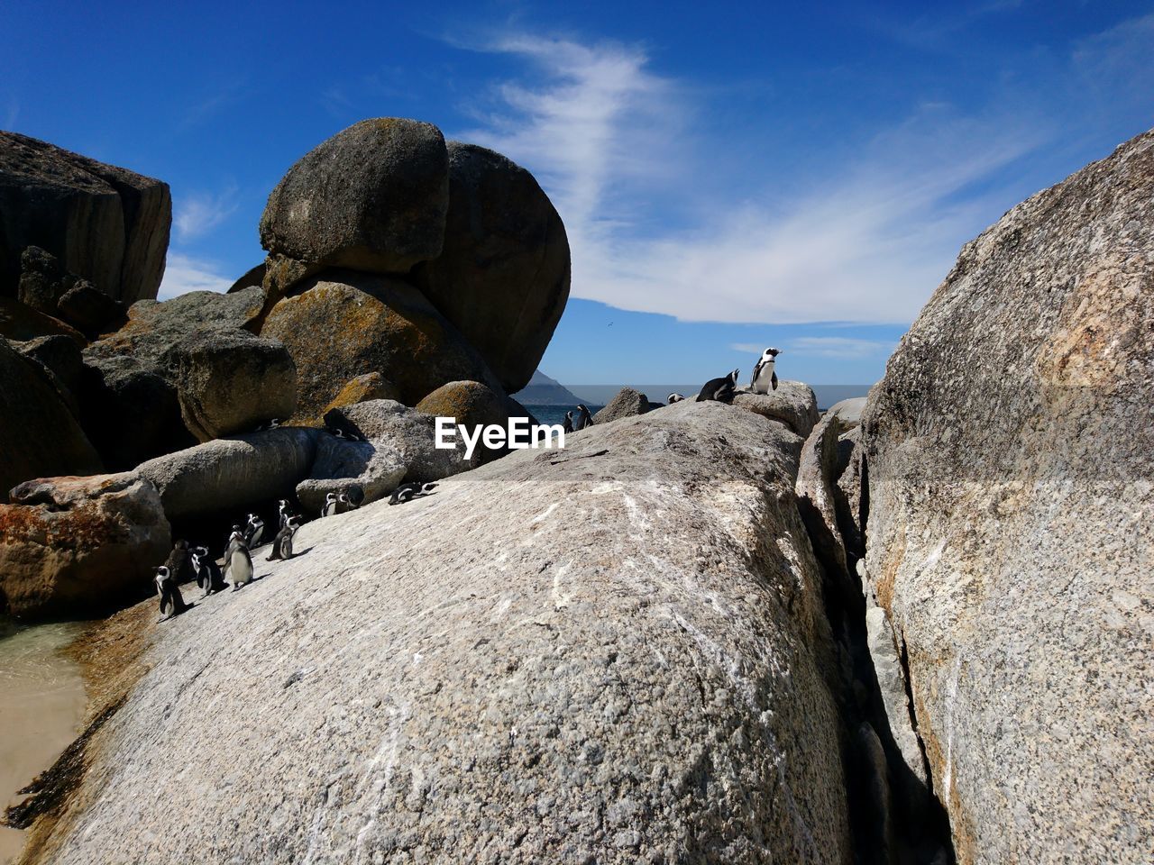 LOW ANGLE VIEW OF ROCK FORMATION AMIDST ROCKS AGAINST SKY