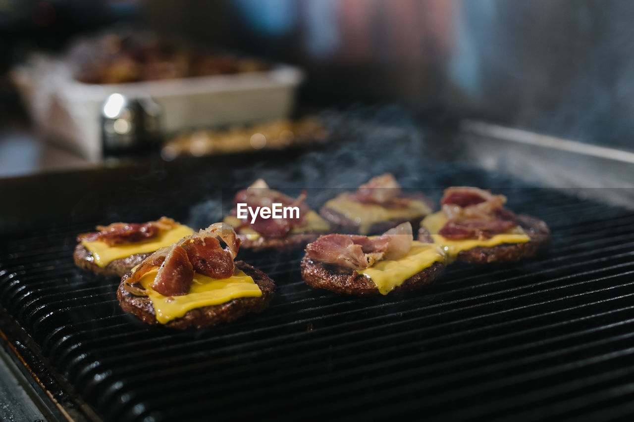 CLOSE-UP OF MEAT ON BARBECUE