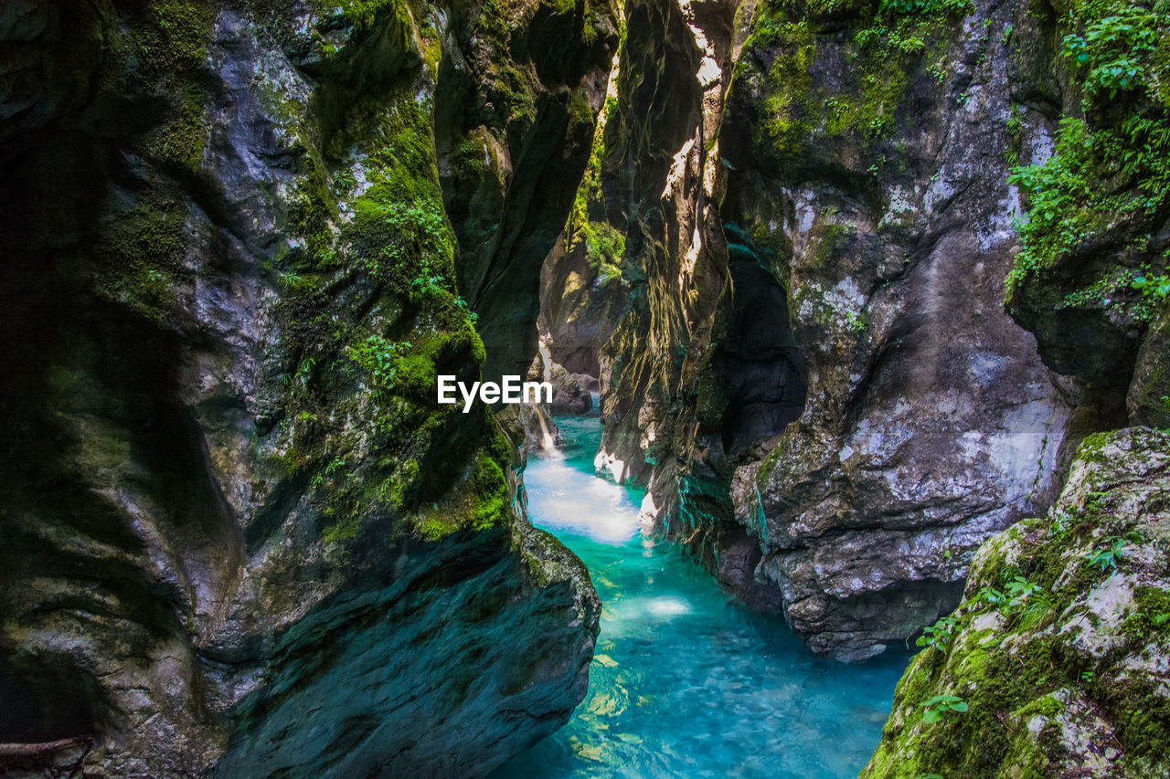 View of stream along rocky cliff