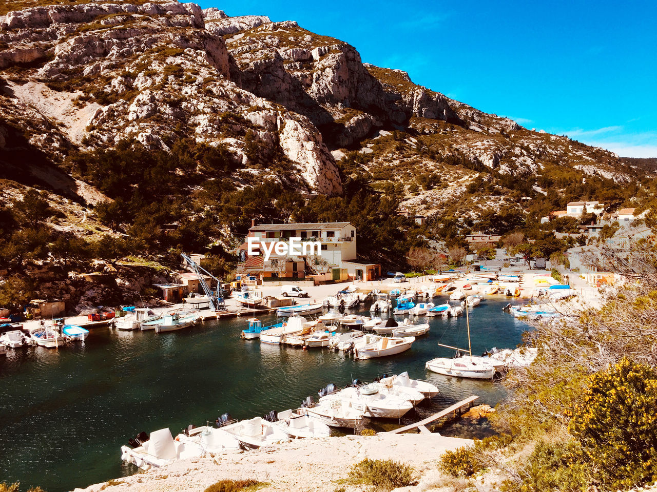 Scenic view of lake and buildings against mountain