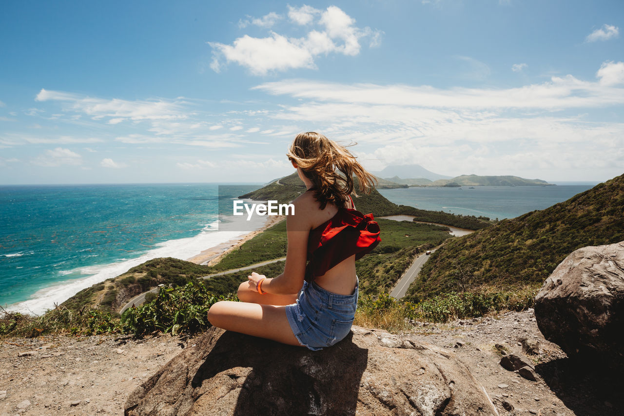 Girl looks out over the caribbean and atlantic ocean stunning views