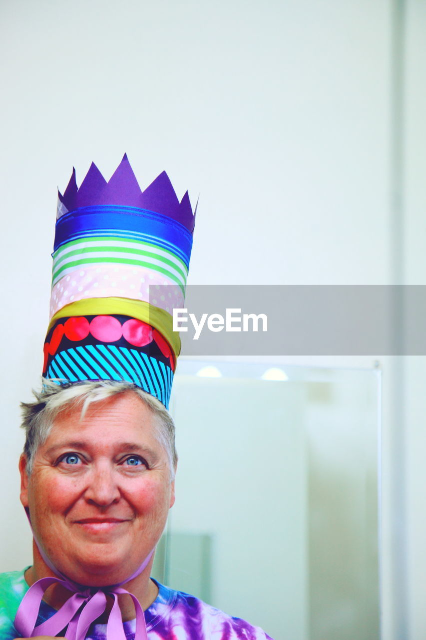 Smiling mature woman wearing birthday hat