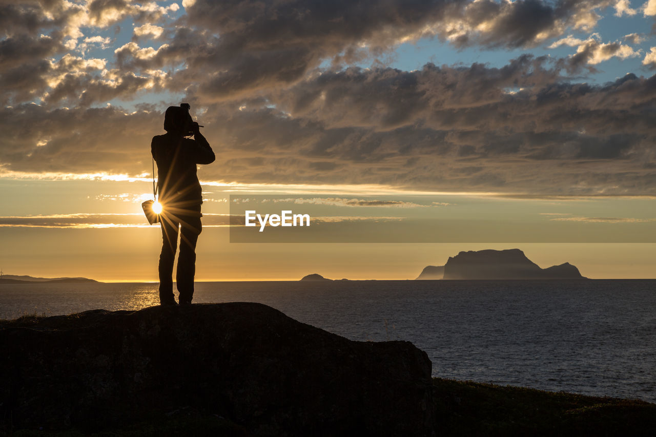 Silhouette man overlooking scenic sky