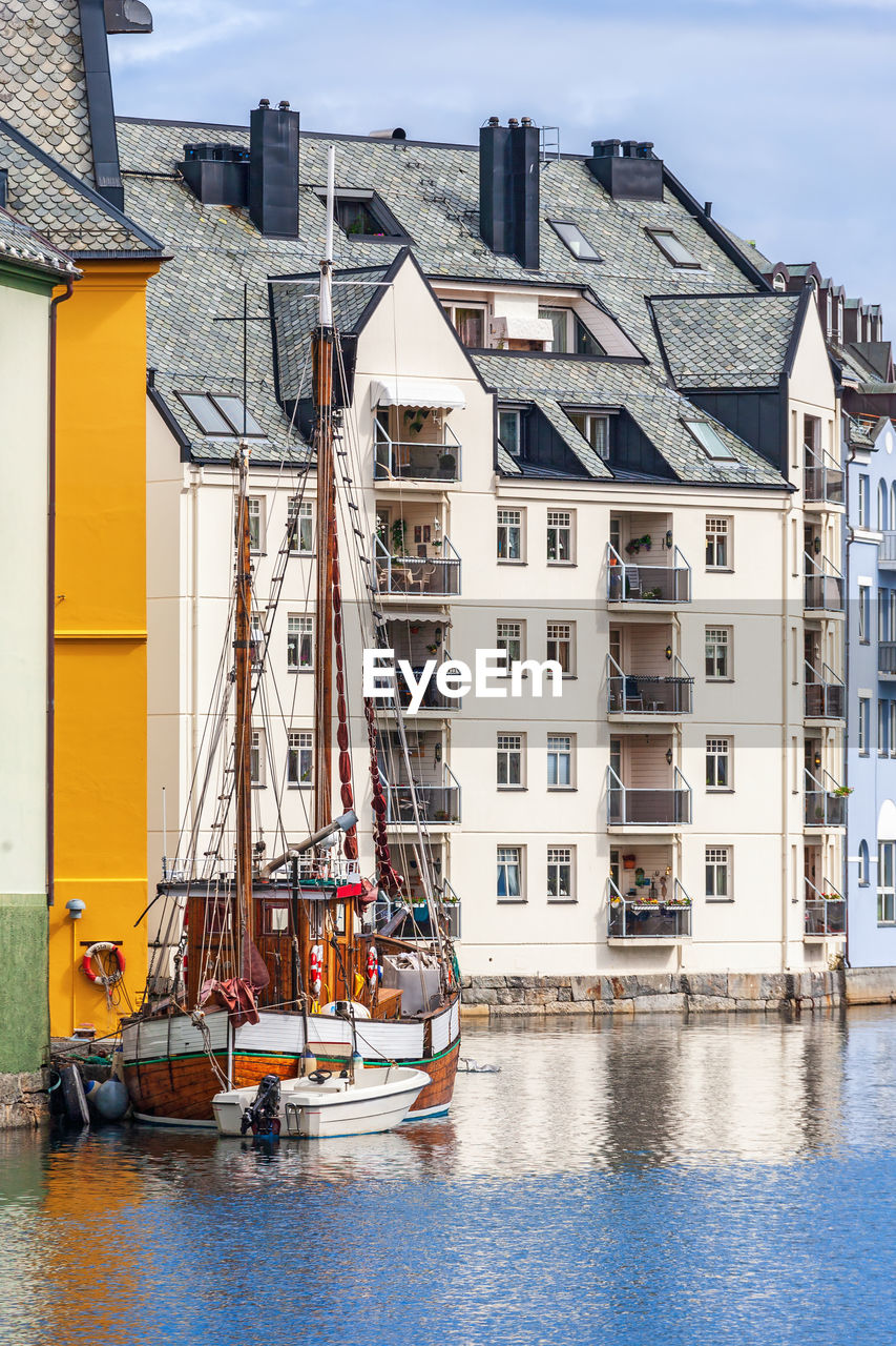 City view at the canal with a ship in alesund, norway