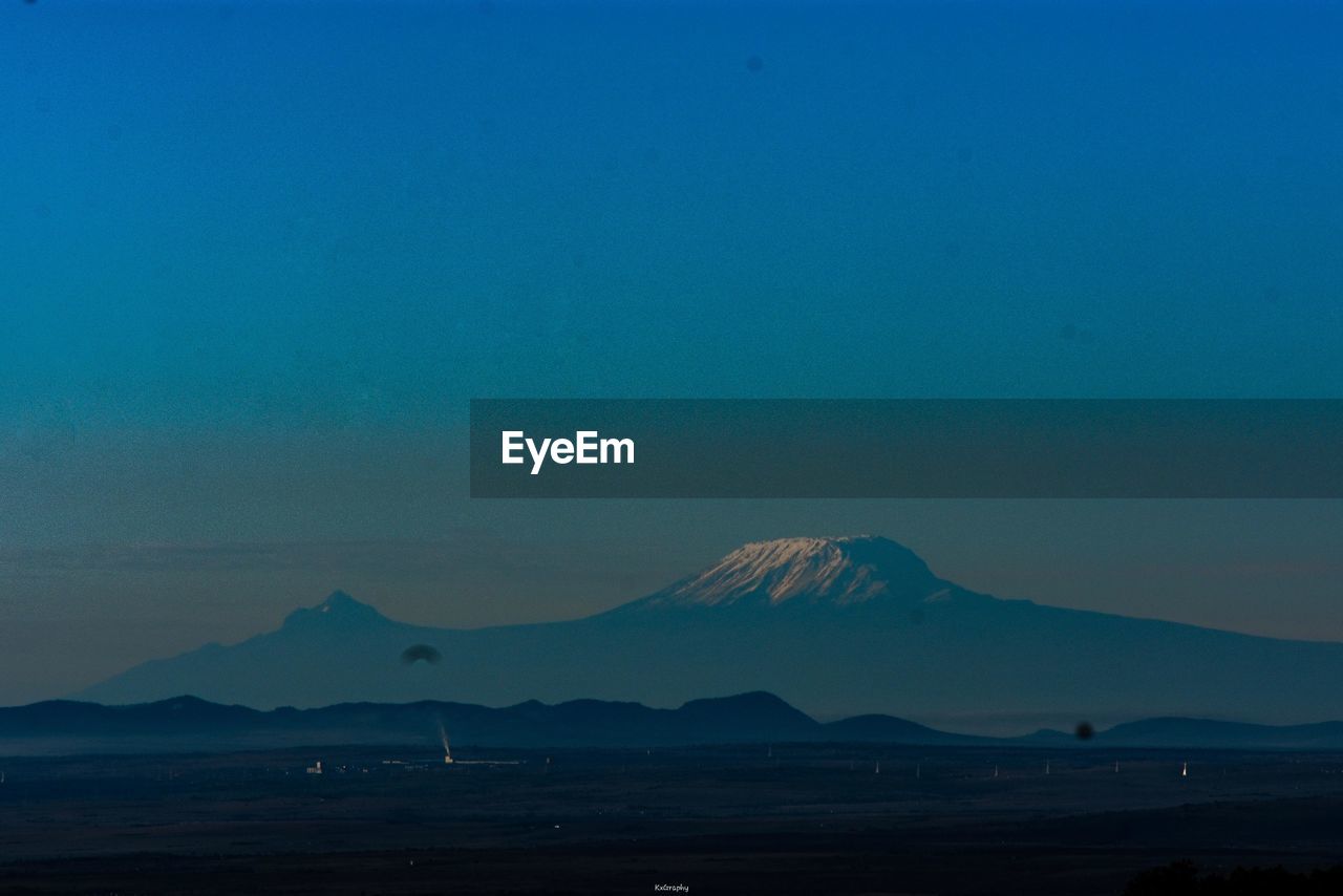 Scenic view of mount kilimanjaro against blue sky