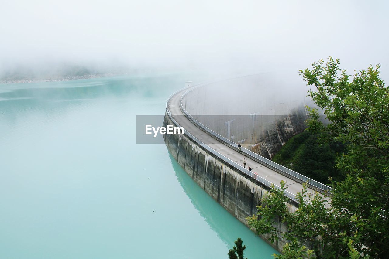 High angle view of dam by river during foggy weather