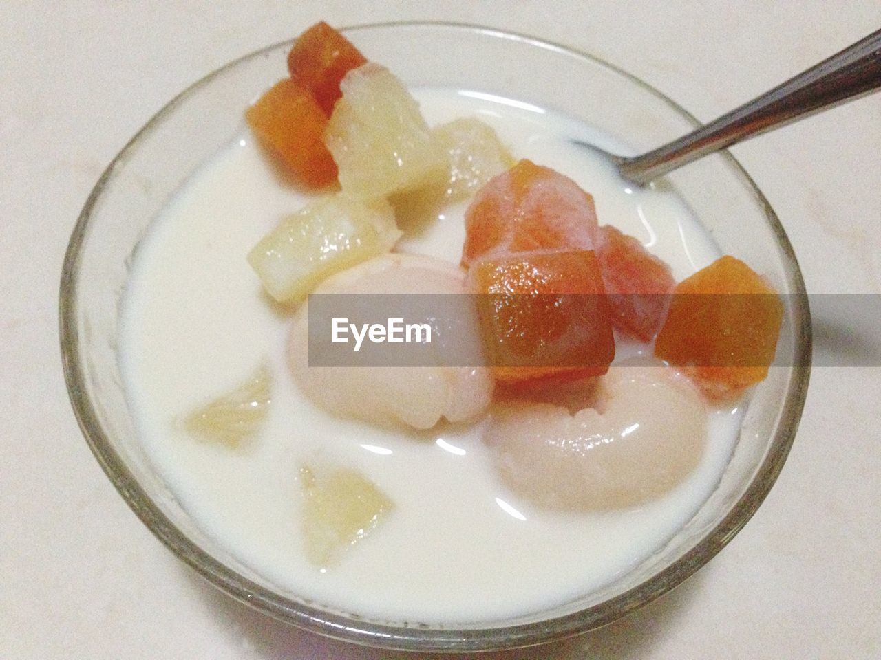 Close-up of fruits with served milk on table