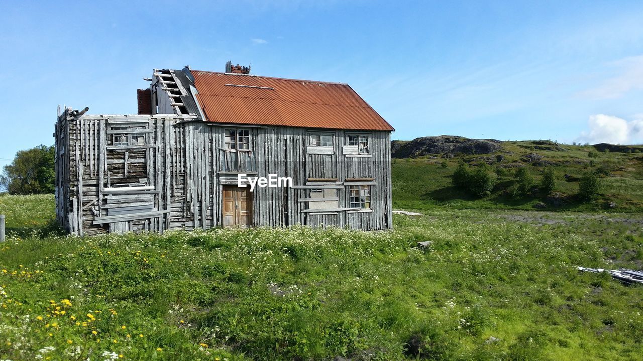 Built structure on grassy field against clear sky