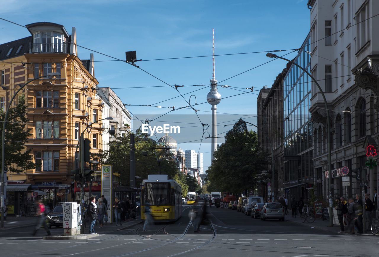 Road amidst buildings against sky