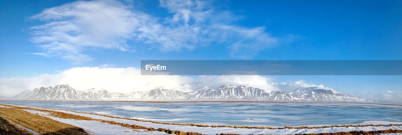 Panoramic view of sea against blue sky