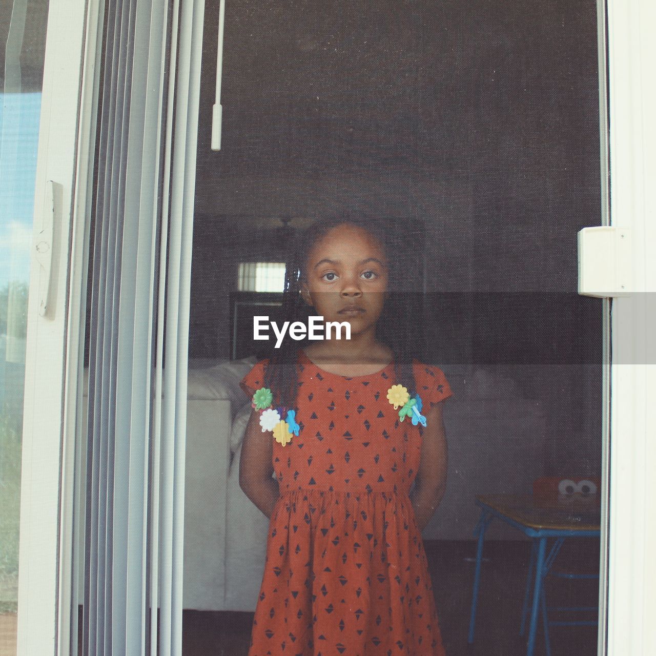 Portrait of girl seen through window