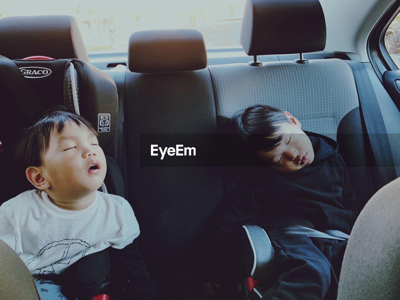 CHILDREN SITTING IN CAR