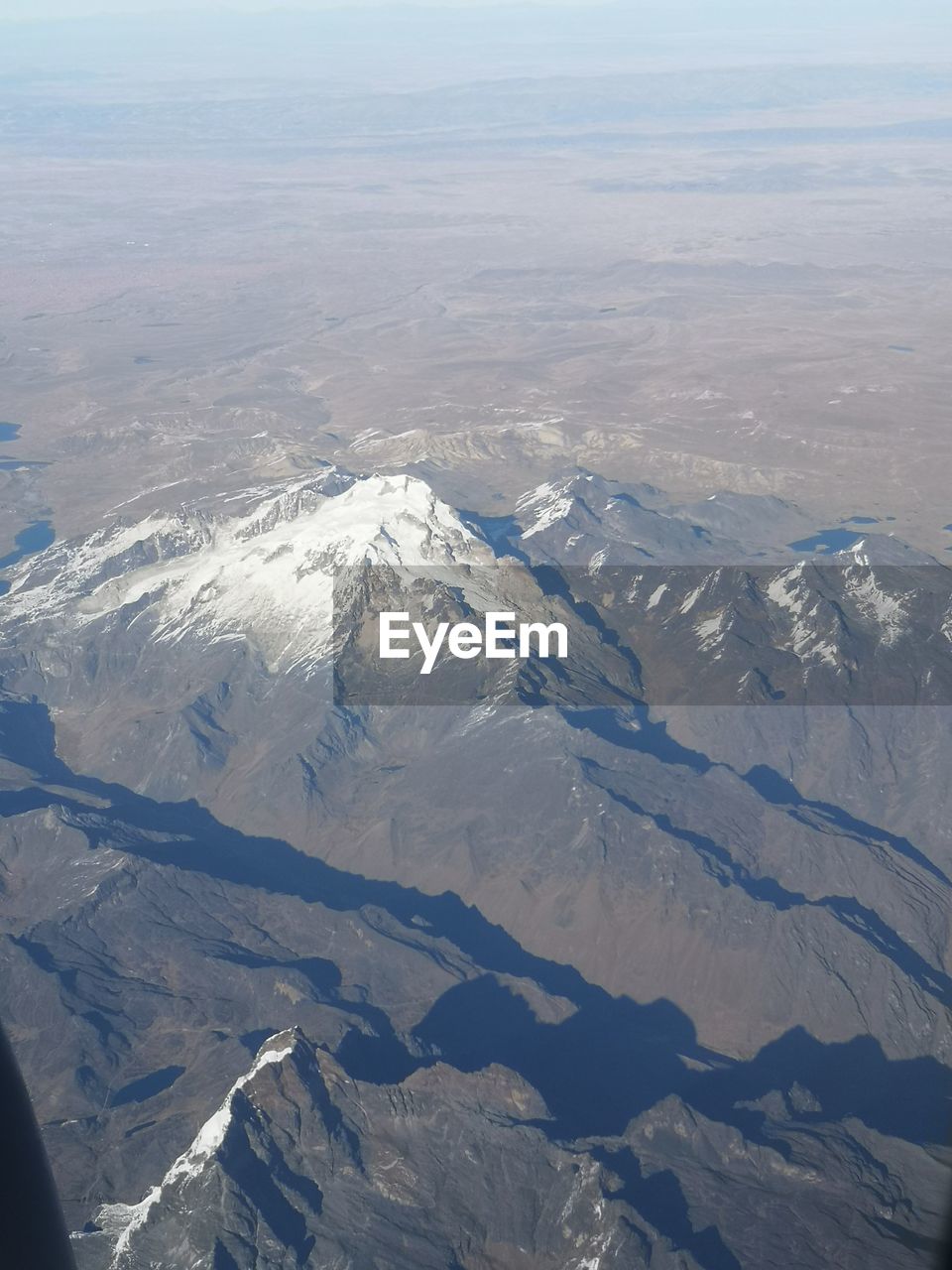 AERIAL VIEW OF SNOW COVERED MOUNTAINS