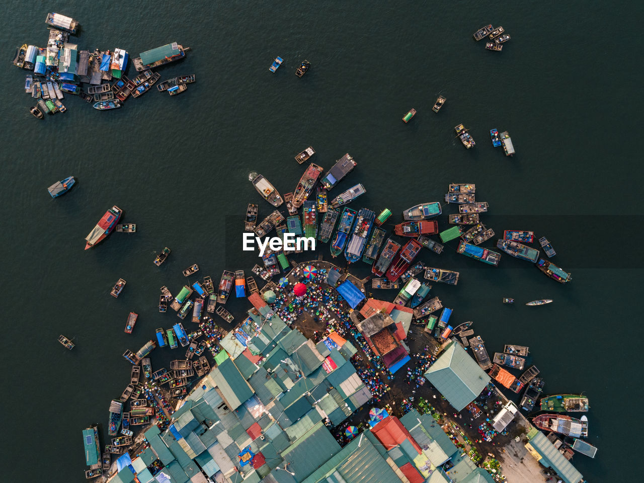 Aerial view of boats moored at harbor in sea