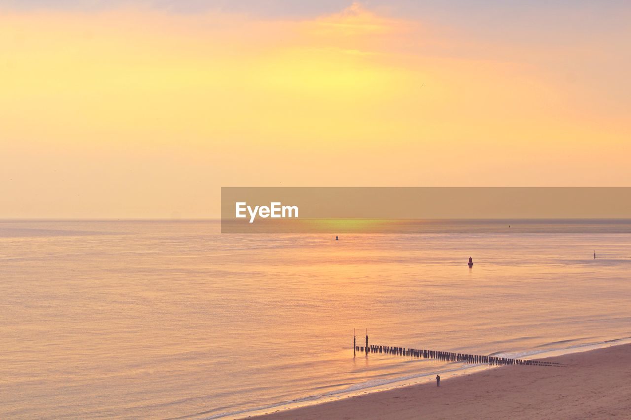 SCENIC VIEW OF BEACH DURING SUNSET