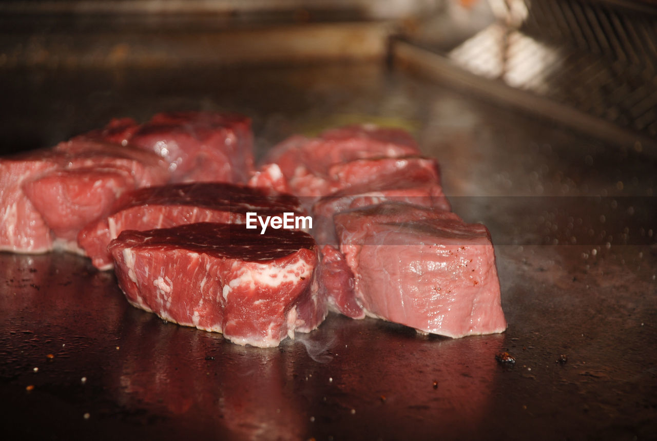 CLOSE-UP OF RED MEAT ON TABLE