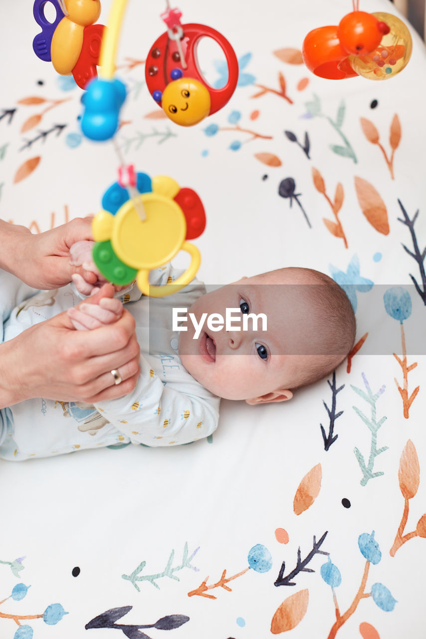 high angle view of cute baby girl with toy on table