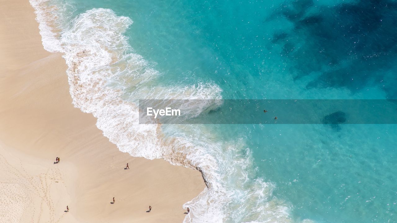 High angle view of waves rushing towards shore