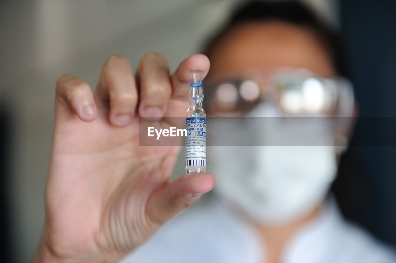 Close-up of woman holding covid vaccine