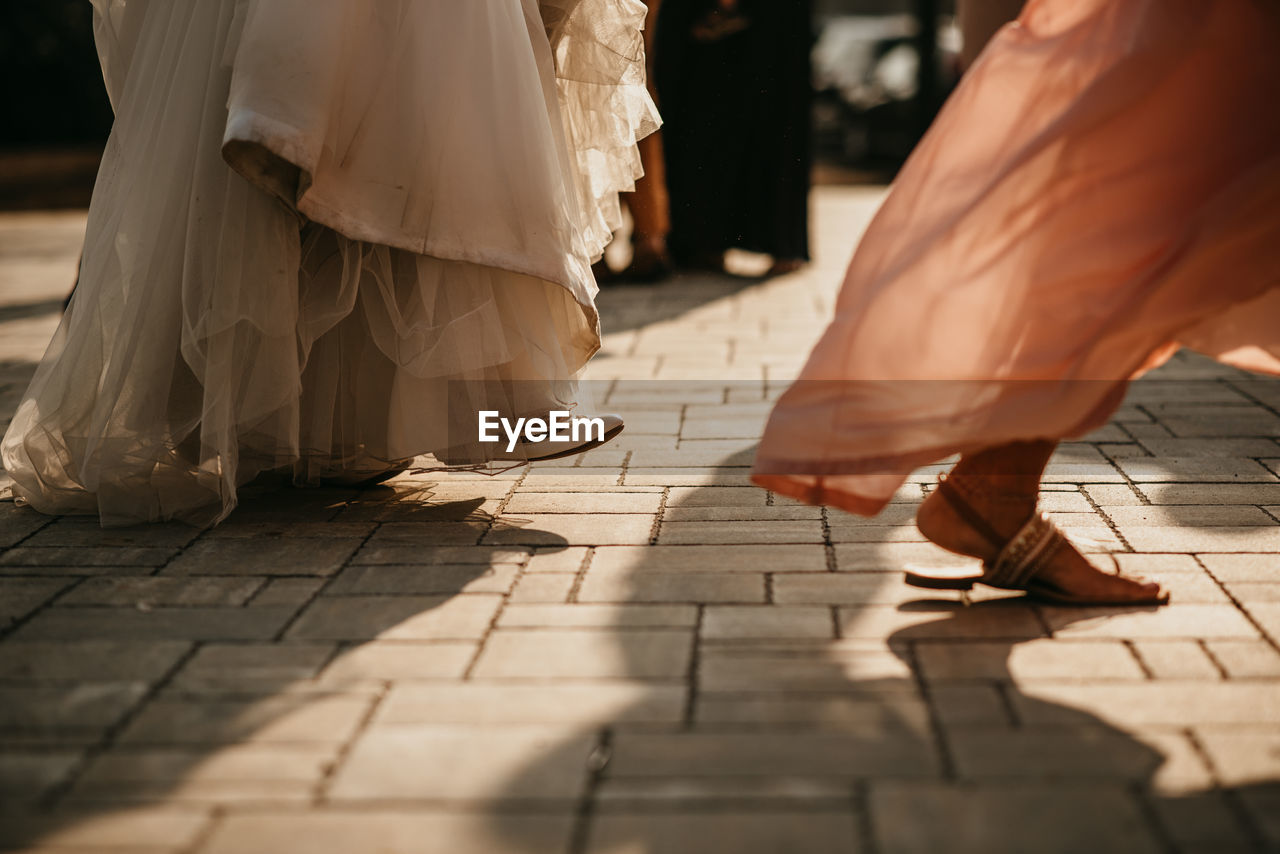 Detail of bride and bridesmaid dancing at wedding party