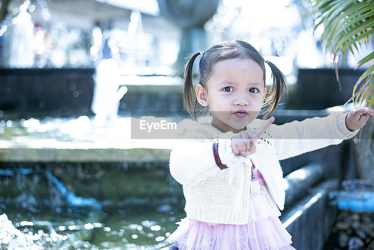 Children play alone in front of the house happily.