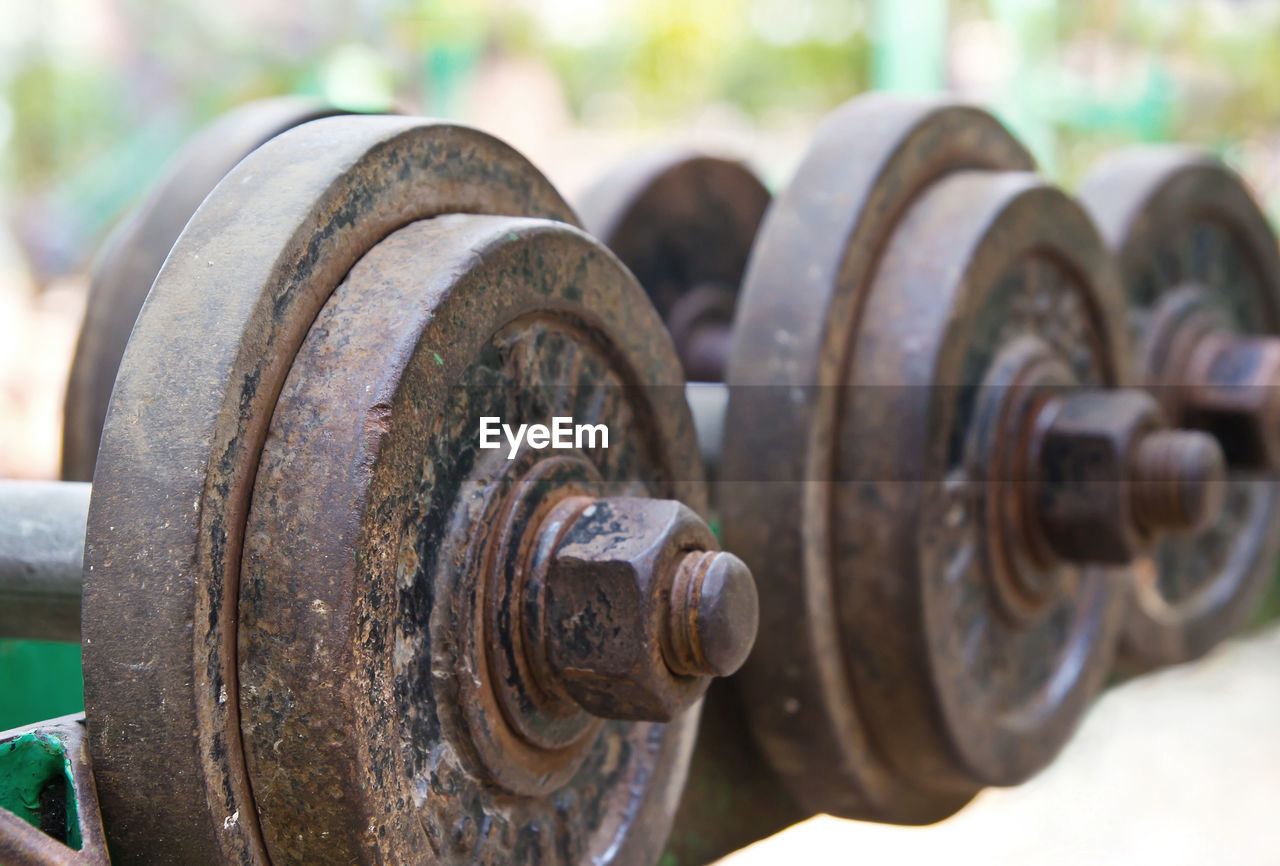 Close-up of rusty dumbbells on rack