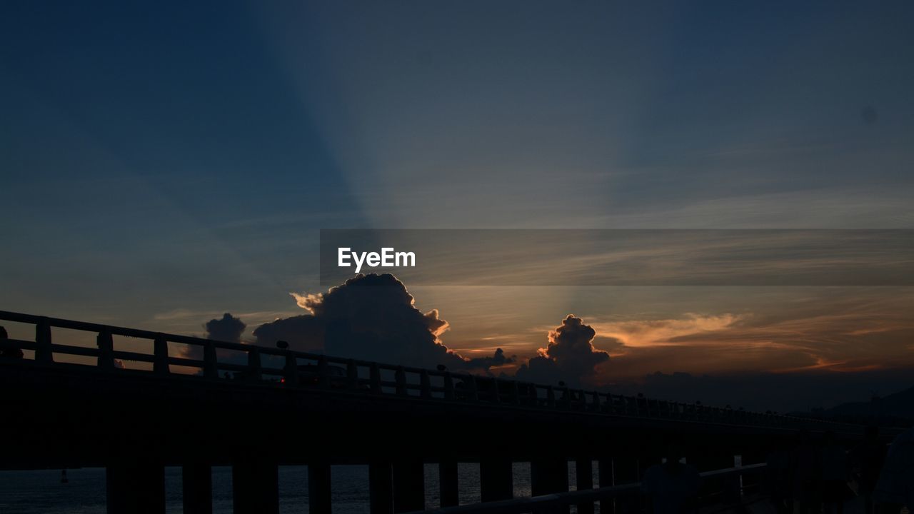 SILHOUETTE BRIDGE OVER WATER AGAINST SKY