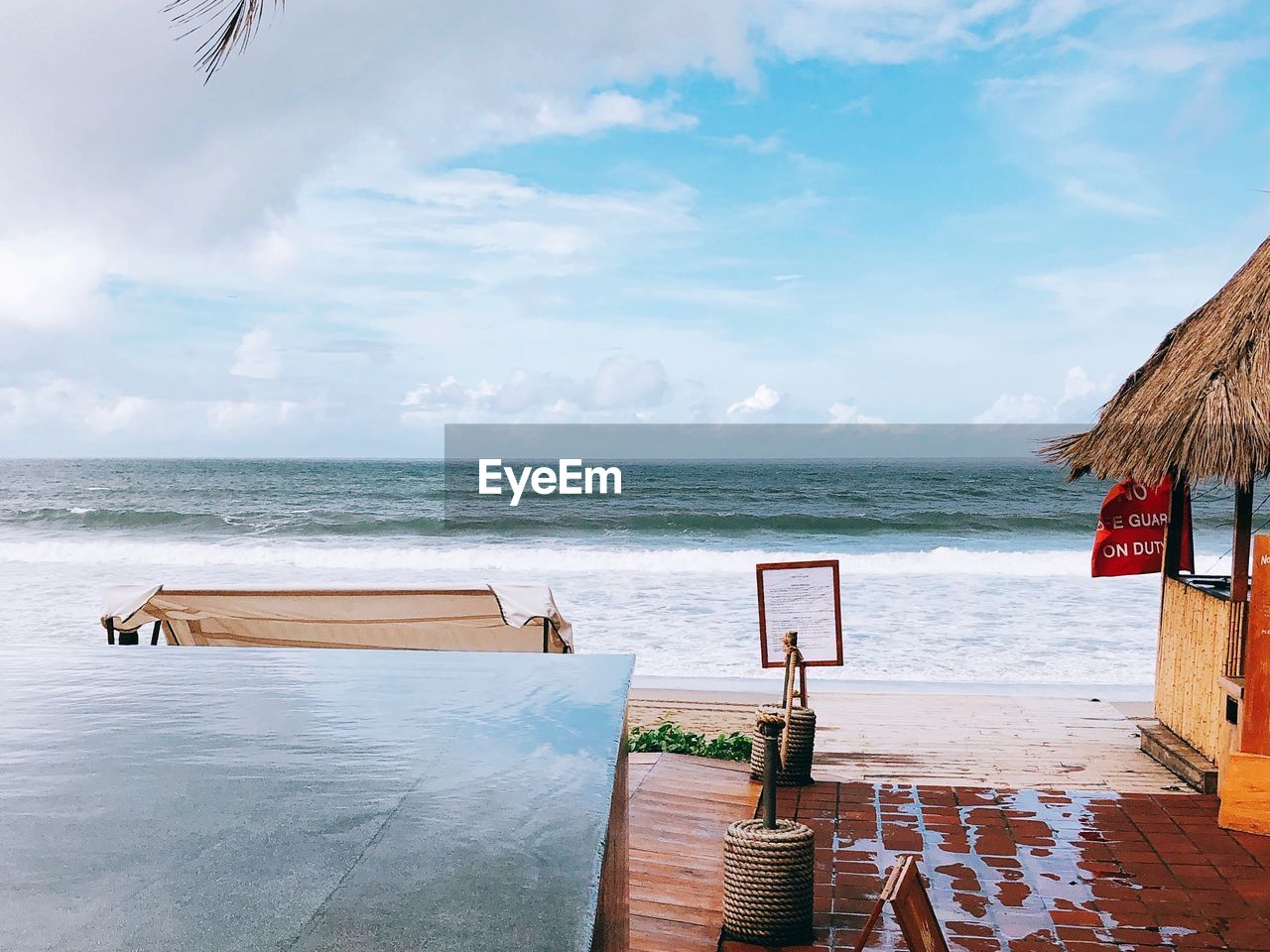 CHAIRS ON BEACH AGAINST SKY