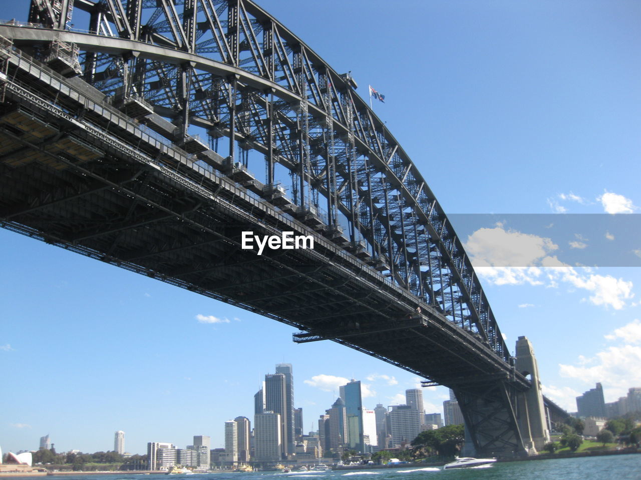 Low angle view of cityscape against blue sky