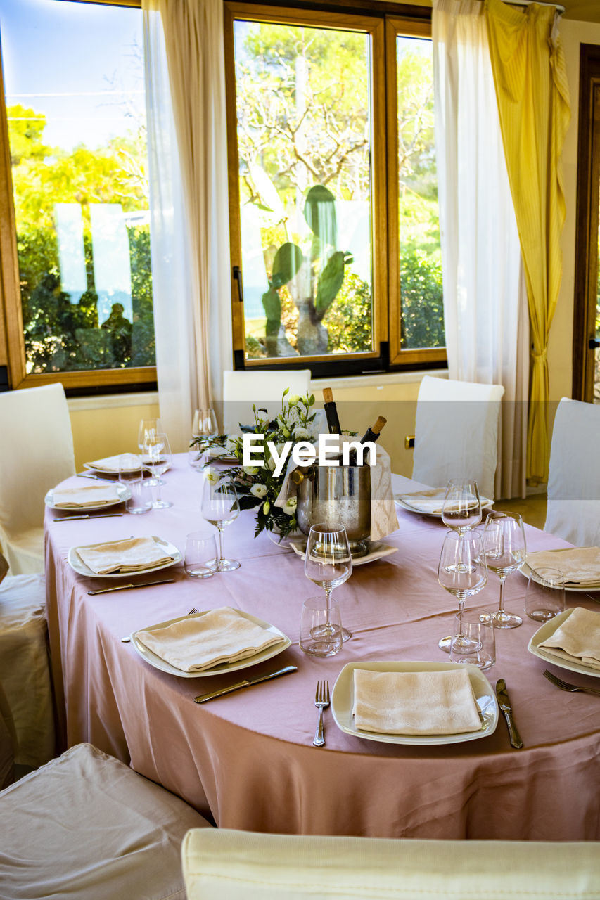 VIEW OF DINING TABLE IN GLASS WINDOW