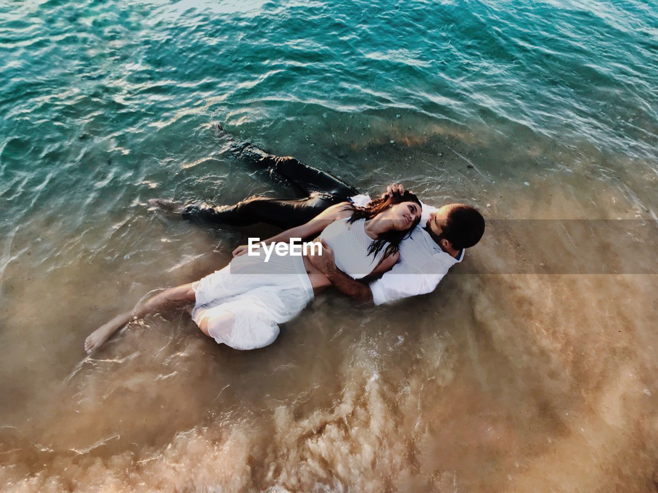 HIGH ANGLE VIEW OF WOMAN RELAXING AT SEA