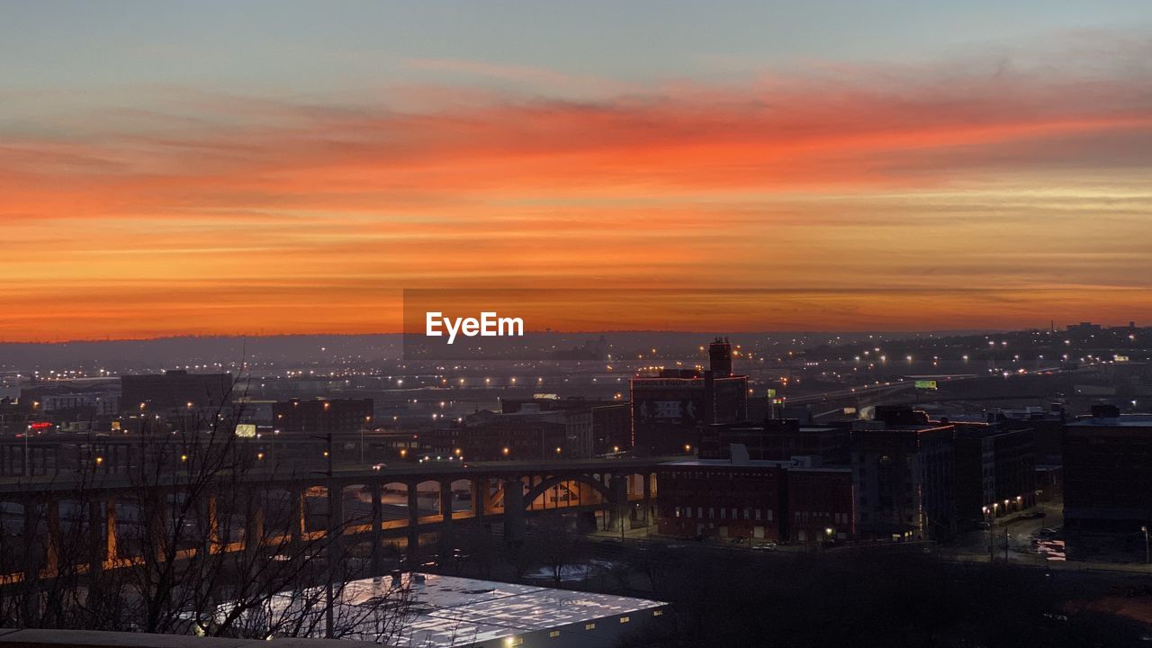 High angle view of illuminated buildings against sky during sunset