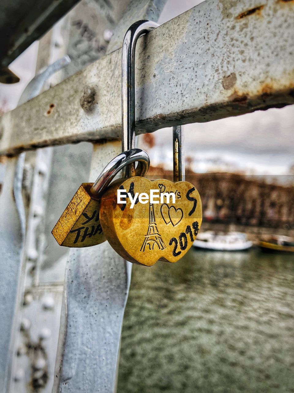 CLOSE-UP OF LOVE PADLOCKS ON RAILING