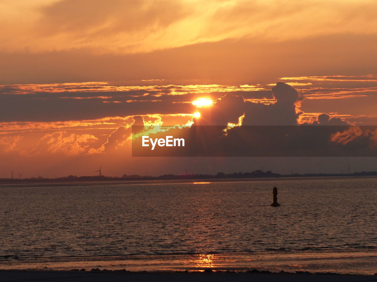 SCENIC VIEW OF SEA AGAINST ORANGE SKY DURING SUNSET