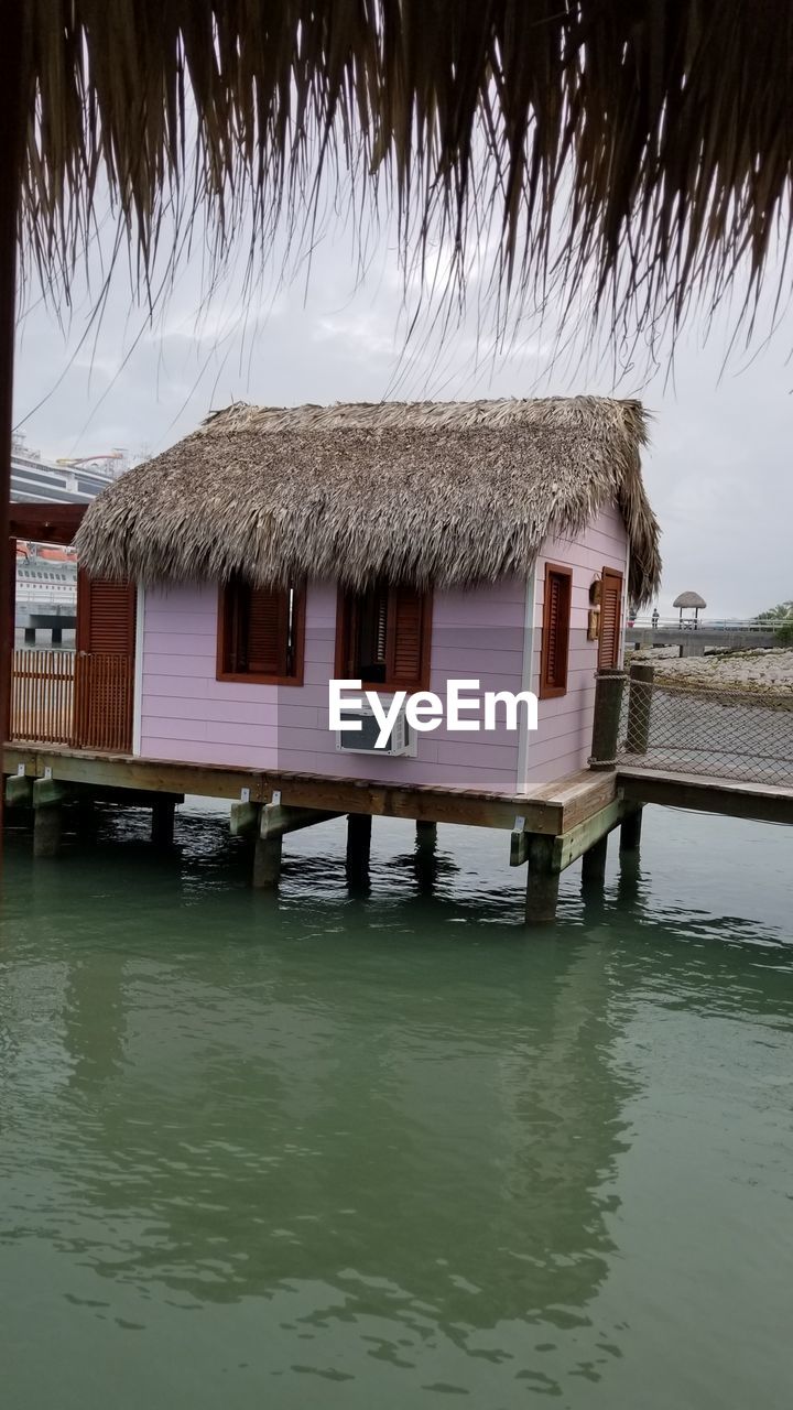 Built structure in water against sky