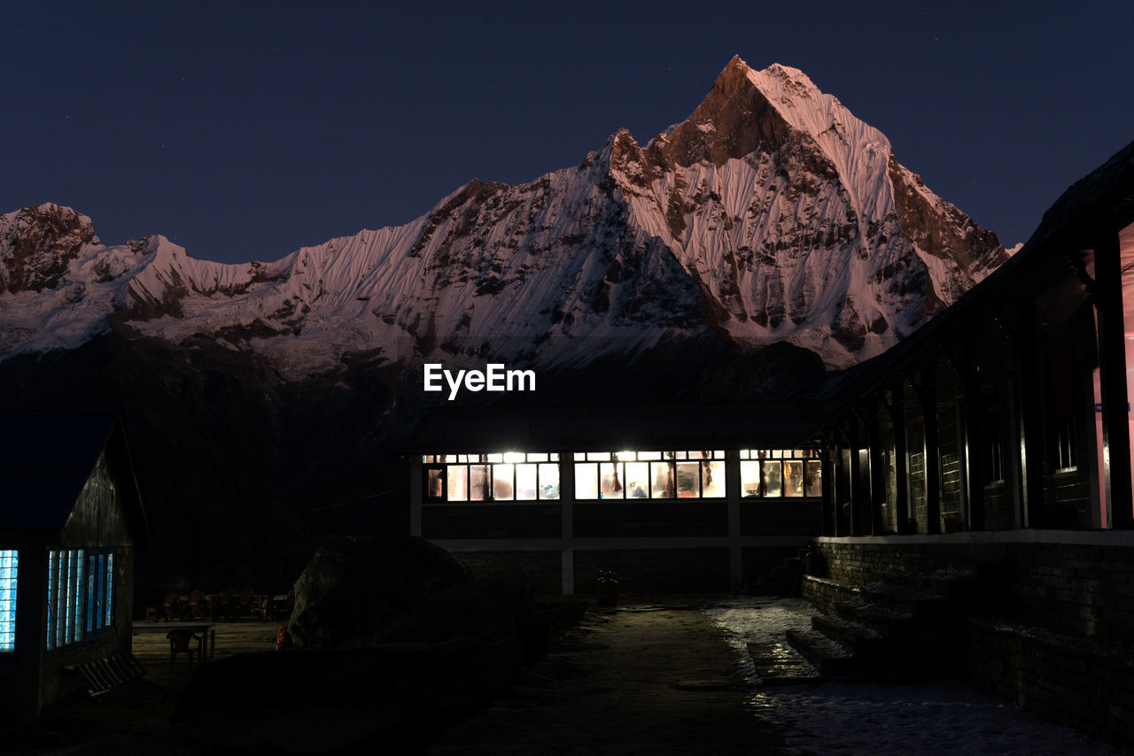 View of building against mountain at twilight