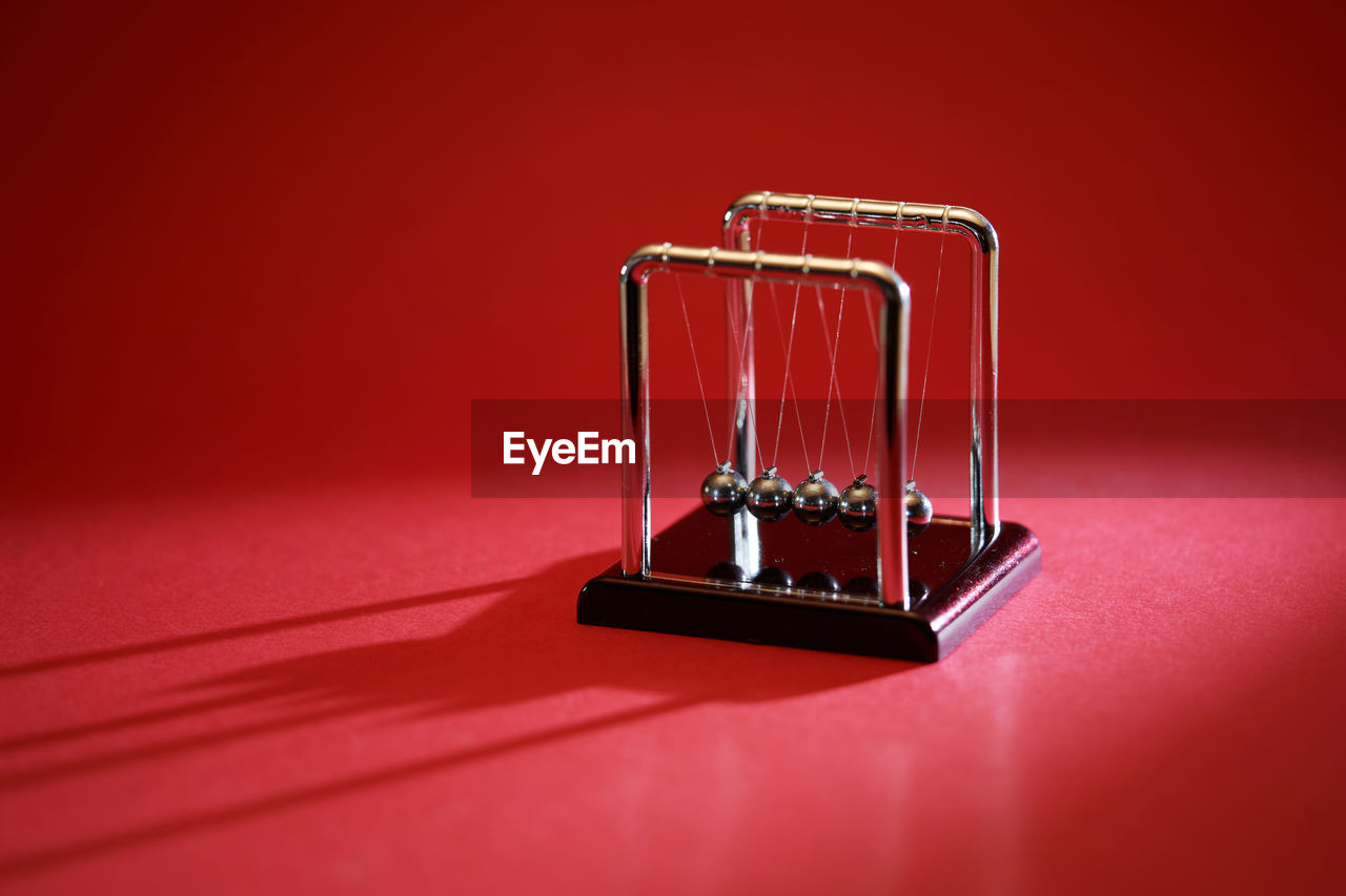 Newton's cradle, concept of conservation of momentum and energy. energy conservation momentum.