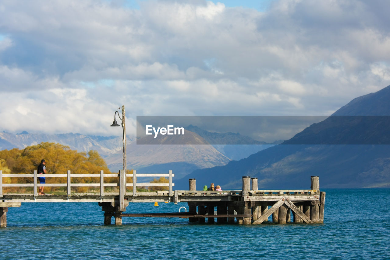 Pier over sea against mountains