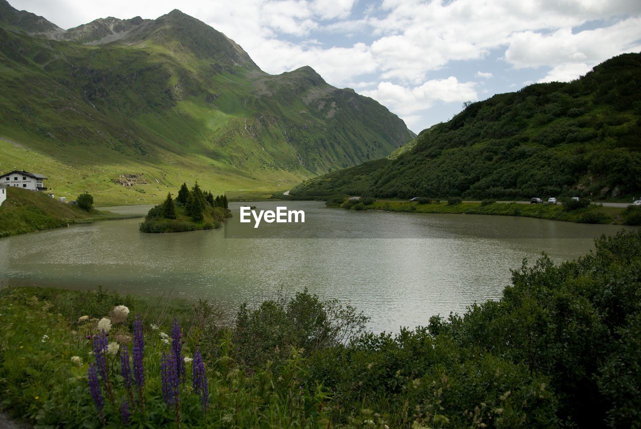 Scenic view of lake and mountains against sky