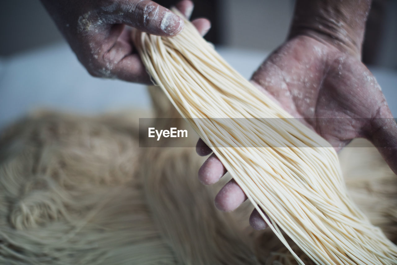 Cropped image of chef making noodles