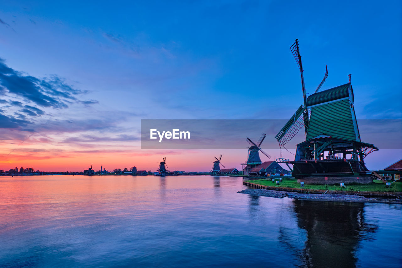 Windmills at famous tourist site zaanse schans in holland with dramatic sky. zaandam, netherlands