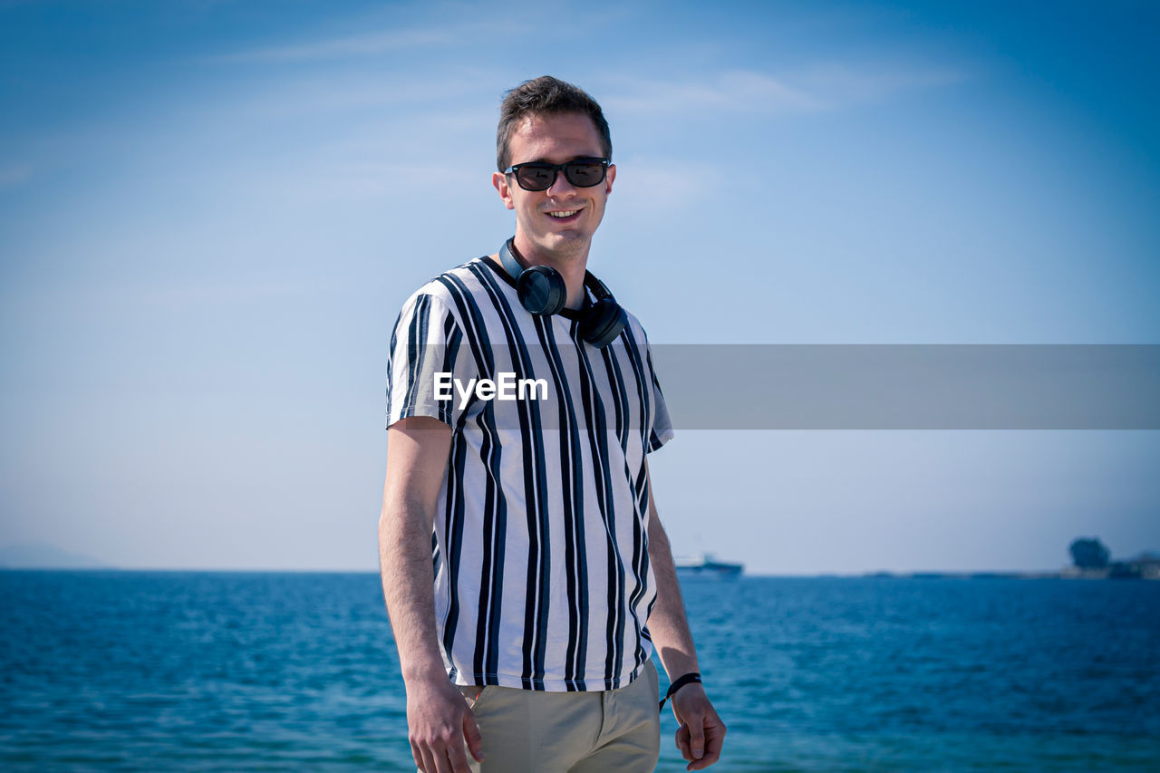 Man walking on the beach with his headphones