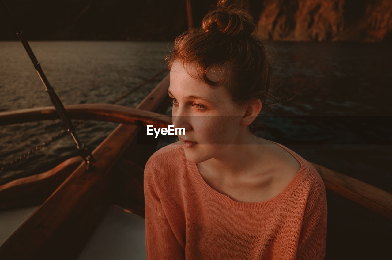 Girl sitting on boat in sea