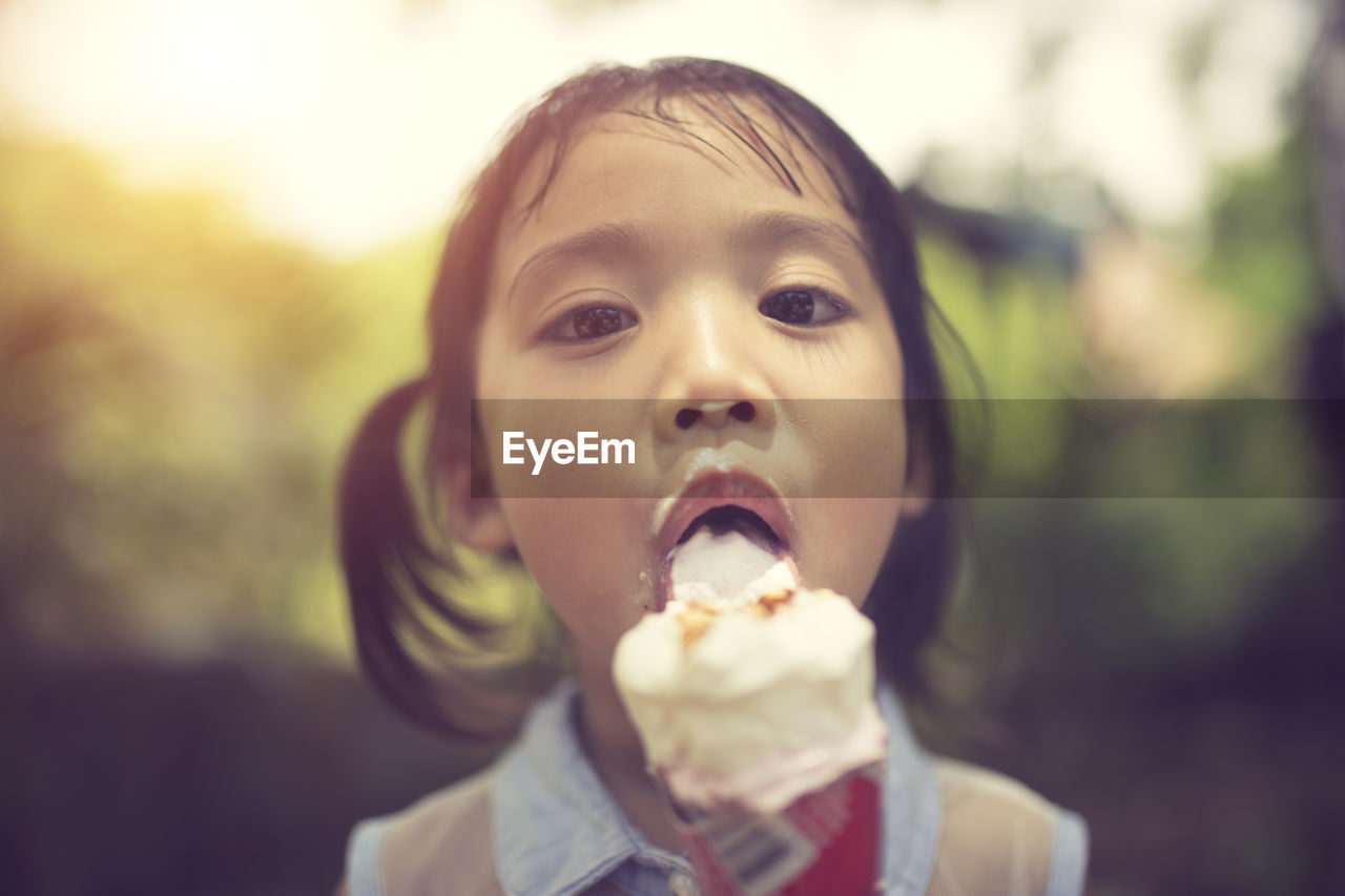 Portrait of cute girl eating ice cream