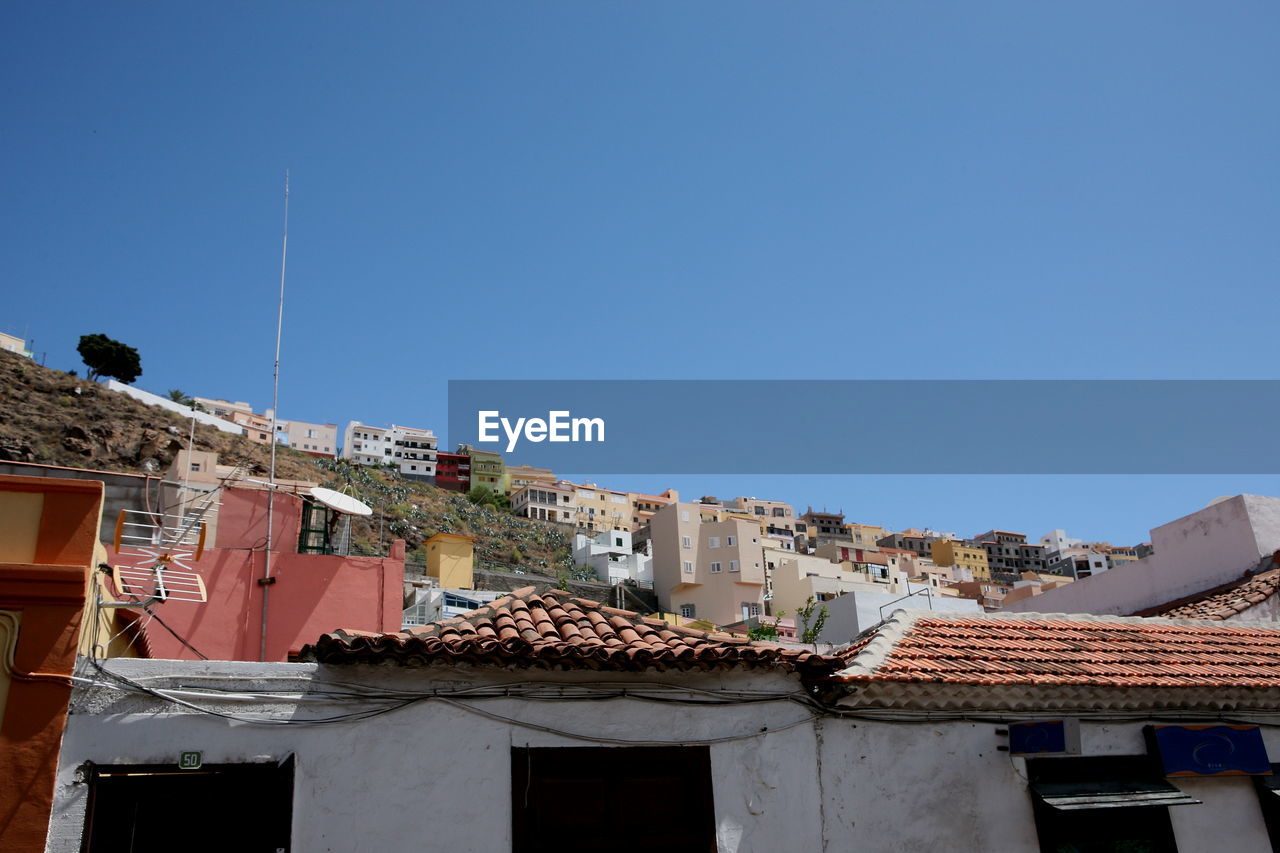 Low angle view of buildings against blue sky