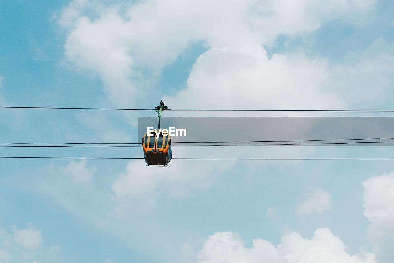 Low angle view of cable car against sky