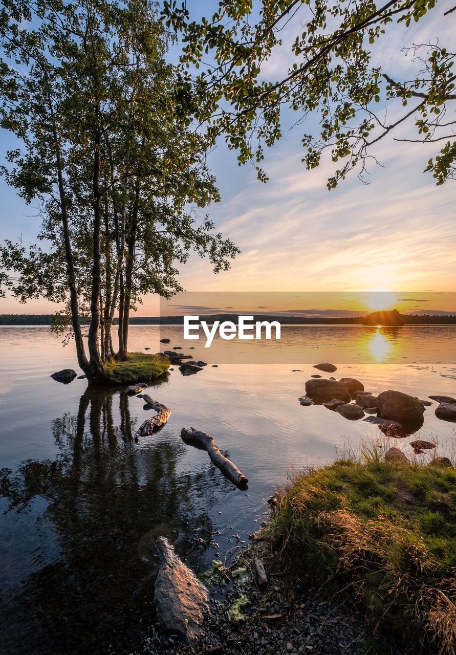 SCENIC VIEW OF LAKE AT SUNSET